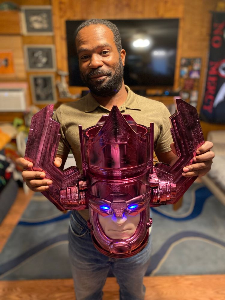 Me holding a popcorn bucket in the shape of Galactus’s head.