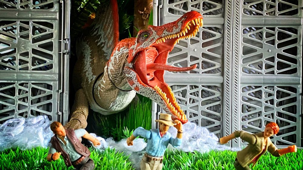 Big dinosaur breaking through gates and three people running away.
