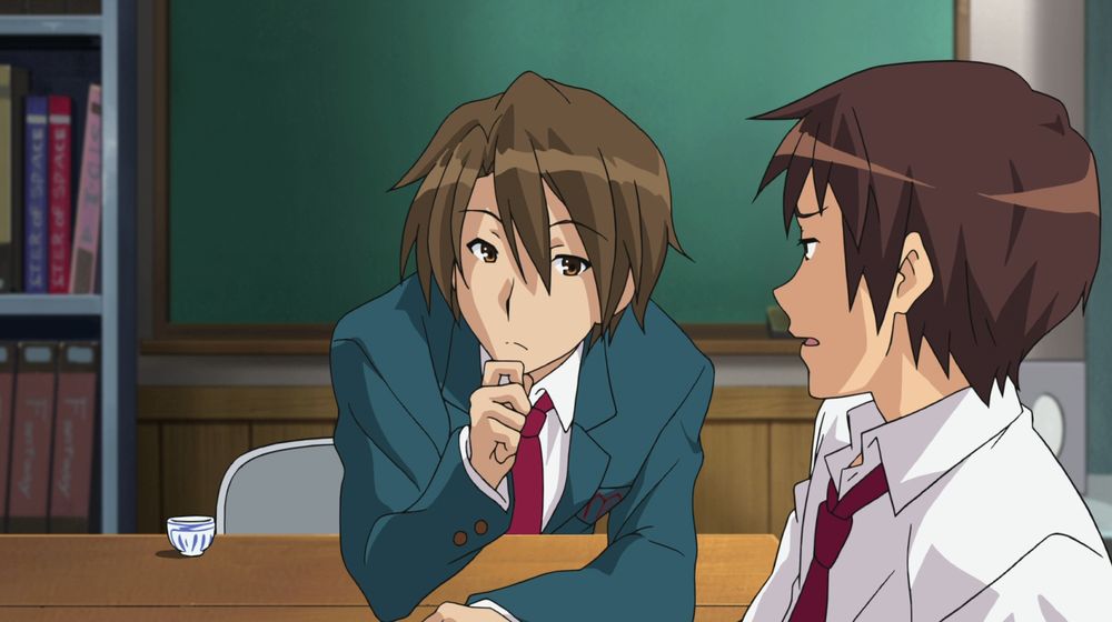 a screencap from The Melancholy of Haruhi Suzumiya. Itsuki Koizumi is leaning across a desk with his hand to his chin, as if pondering something. his friend Kyon sits across from him, slightly perturbed by this behavior.
