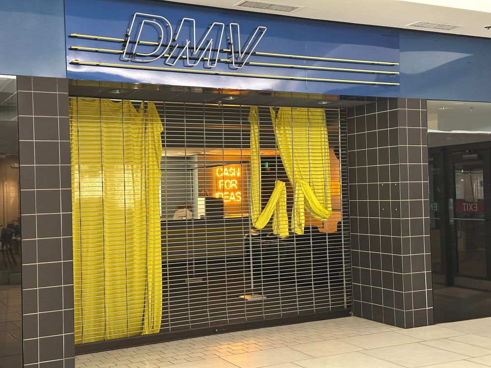 A closed Oregon DMV with an illuminated sign inside that reads “cash for ideas”