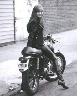 Patti Scialfa seated on a motorcycle