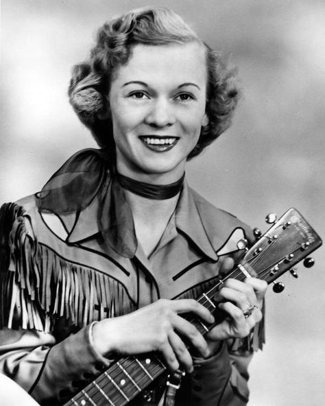 Jean Shepard holding the neck of a her guitar