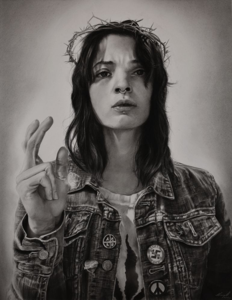 A realistic pastel and charcoal drawing of a modern Jesus as a woman. She is wearing a jean jacket with pins showing support for Black Lives Matter, Love is Love, Peace, and one saying "Never Again" with a cross through a nazi symbol.