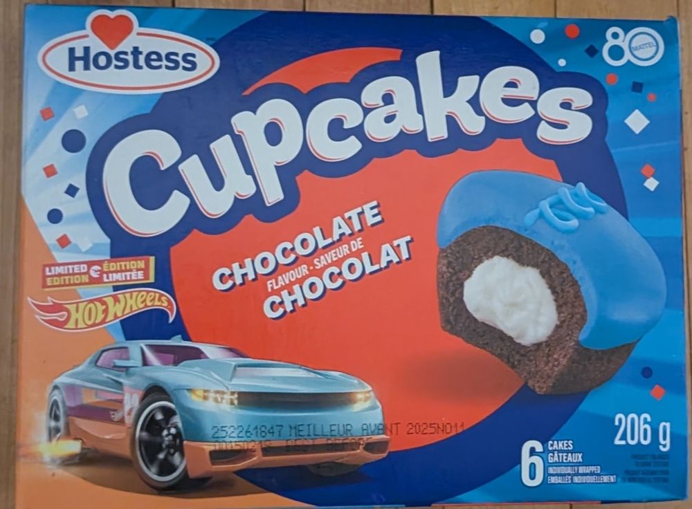 A box of Limited Edition Hot wheels hostess cupcakes chocolate flavor with blue icing on top and white in the middle.