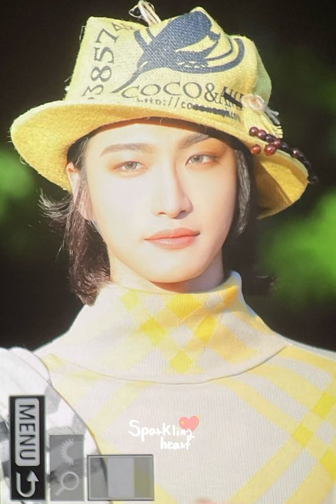 ateez member Seonghwa also smiling softly and wearing a yellow hat and shirt and looking especially bunny like