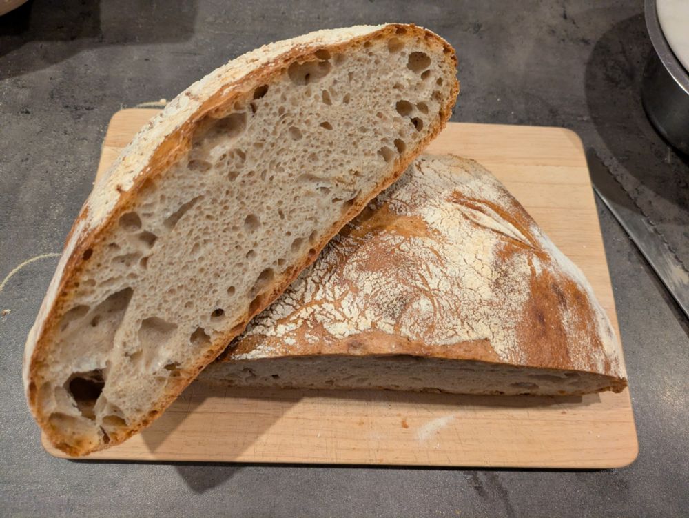 Bread with uneven porous structure and thick crunchy crust.