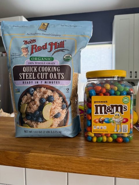 Picture of  a 7 pound bag of Oatmeal beside a 4 pound jar of M&Ms for scale.