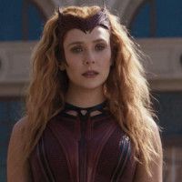 The character Wanda Maximoff from Wandavision. She looks mad, or disappointed. Maybe disillusioned. Universe-bending powers’ll do that to you. 