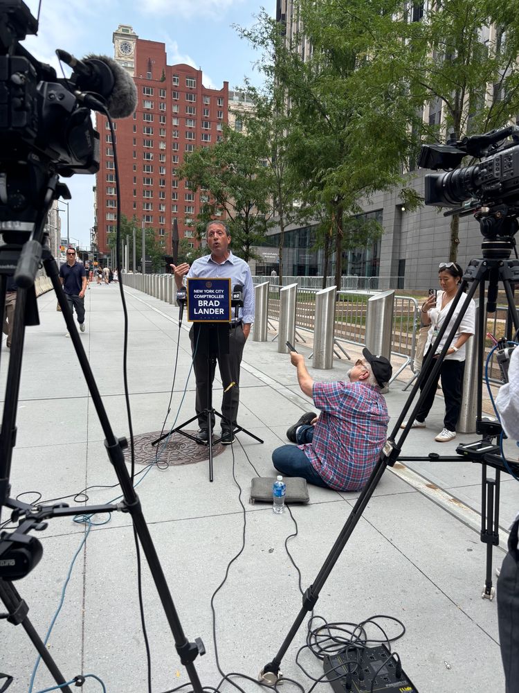 Brad Lander speaking to press behind a mic stand that says his name and that he is comptroller

He is standing on the sidewalk outside the Manhattan federal building where immigration hearings and abductions are occurring 