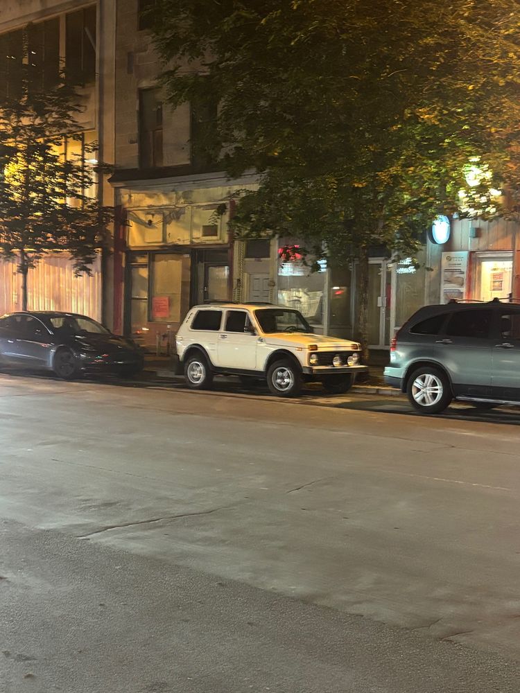 Canadian market white Lada niva (called a Cossack here. Really) parallel parked on a Montreal street