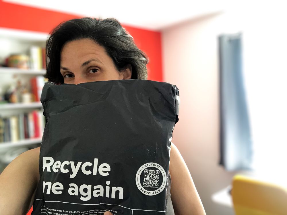 Liz Publika holding up recycled packaging from The ARTpublika Shop 
