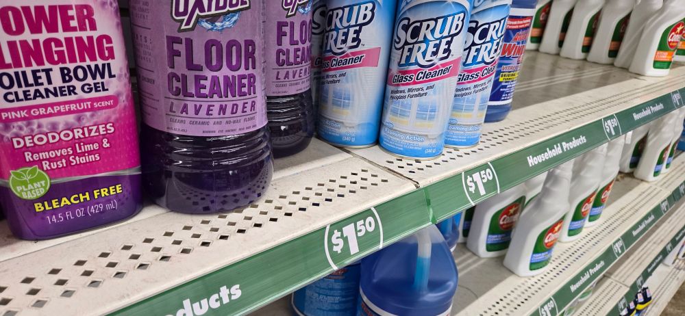 Picture of cleaning supplies. Shelf says $1.50.