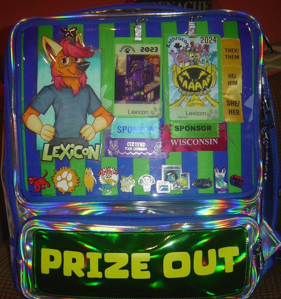 Right side of the pack, showcasing an ita bag slot with a character badge as well as convention badges for Anthrocon 2023 and 2024 along the top, and various pins assorted by color lined along the bottom.