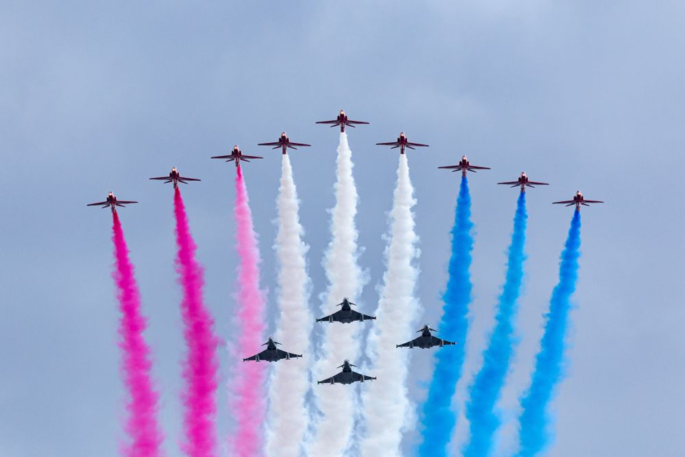 The Royal Air Force Red Arrows & four Eurofighter Typhoons fly over Buckingham Palace. 