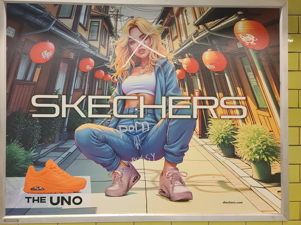 an ad for sketchers that's been defaced with graffiti. The anime-style girl is clearly AI and posed in a suggestive position with her crotch open and jutting towards the camera (she is fully clothed). This is an ad for sneakers. Someone drew a vagina on her jeans-crotch and writes 