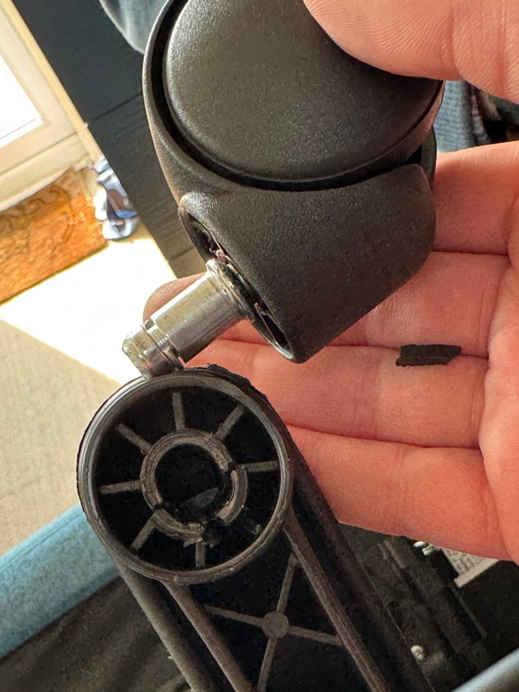 Picture of the broken wheel housing dock/connector of my office chair. The chair lasted two weeks.