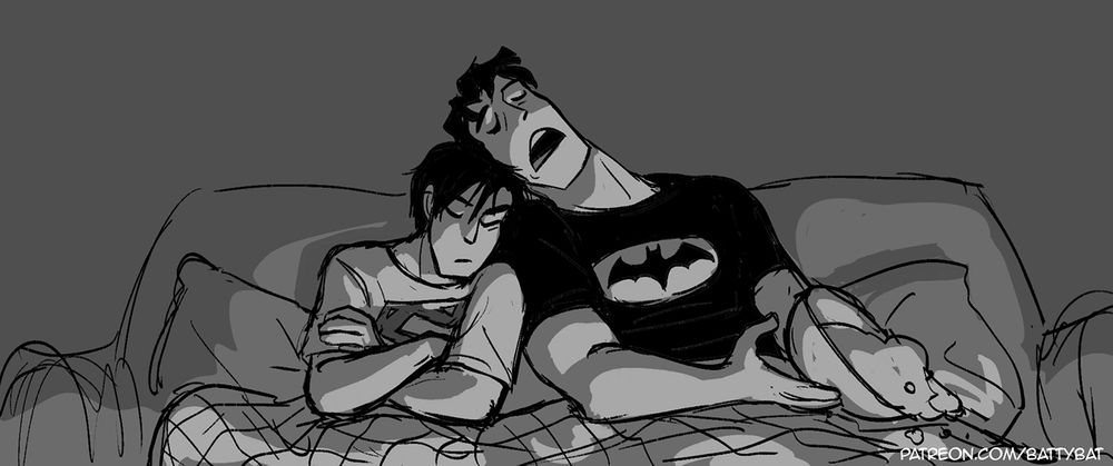 Bruce and Clark, each wearing the others merch, fall asleep with their heads against each other while watching TV, a tipped over popcorn bowl in Clark's hands.