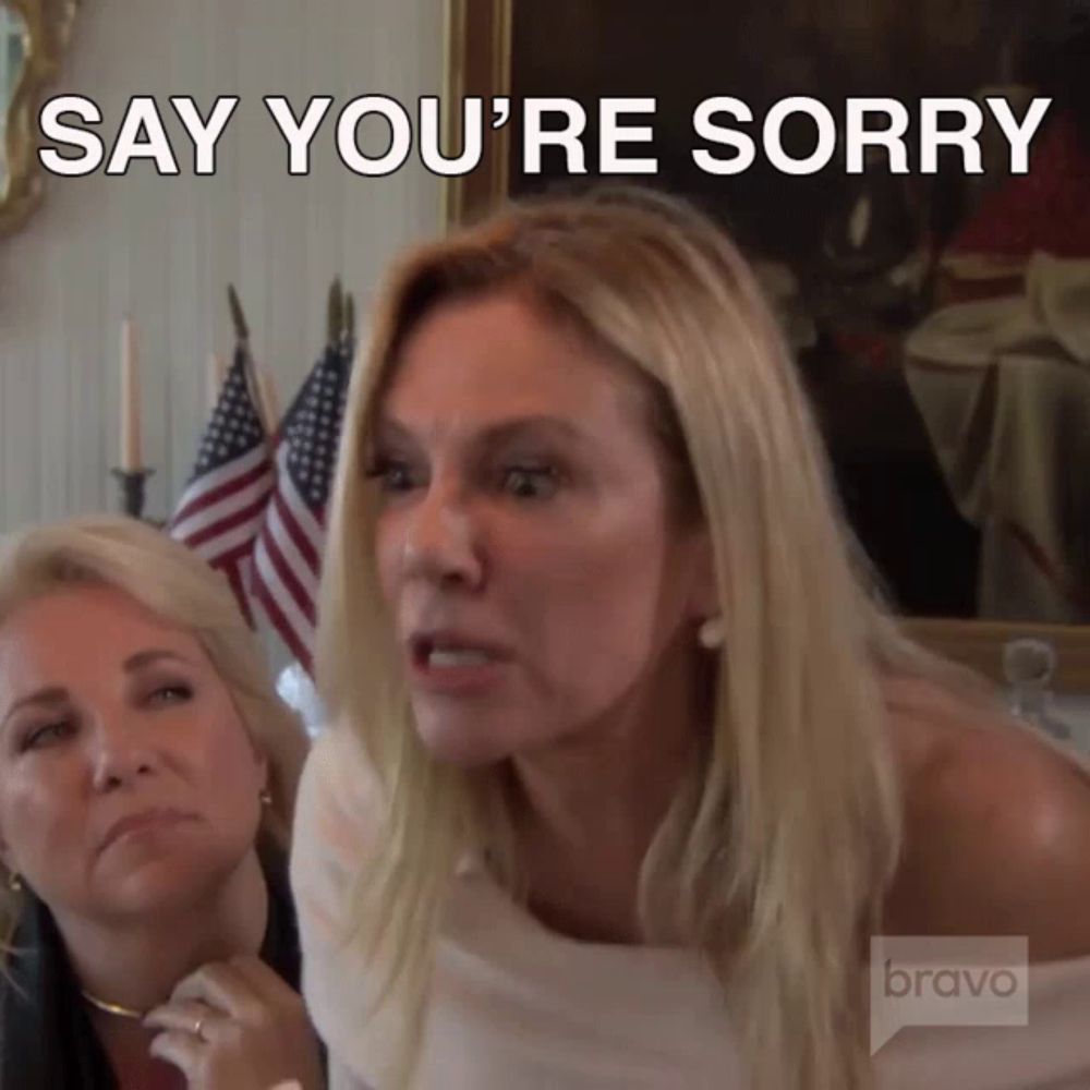 a woman says " say you 're sorry " in front of a bravo logo