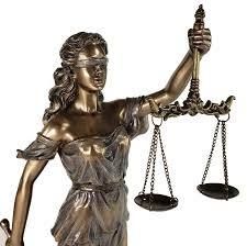 Blind justice statue holding a sword and scales
