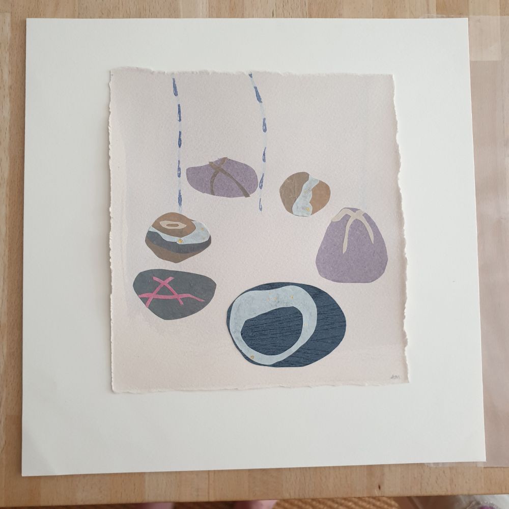 Collage on paper of 6 pebbles in a circle, cut for layers of relief printed paper 