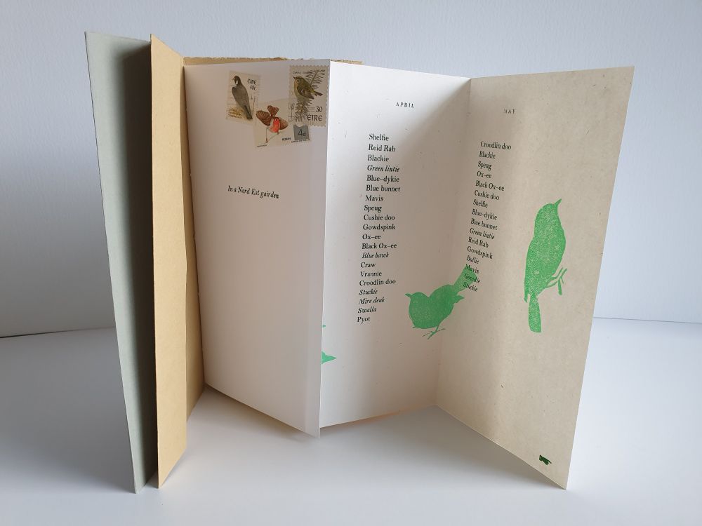 Open book with 3 pages folding out in concertina showing green bird shapes with list of bird names in Scottish language in 2 columns 1 page has stamps with bird images top right.