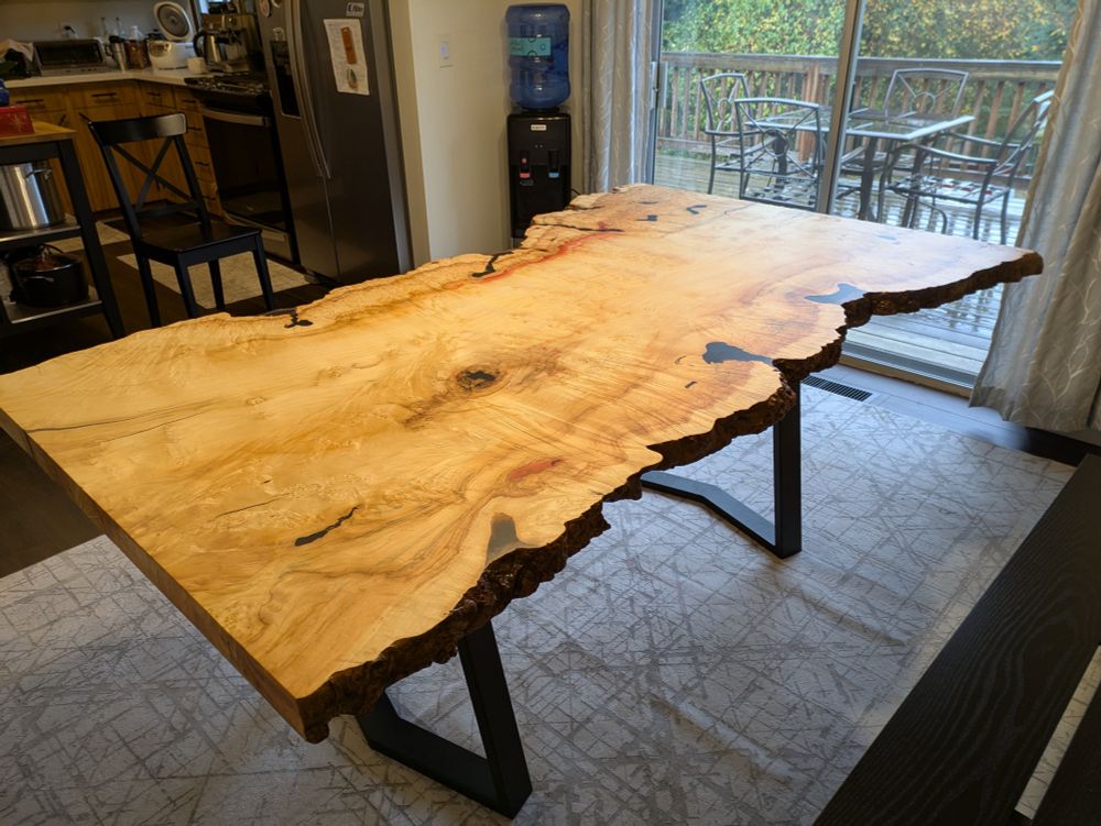 Long table on black Chevron legs at an angle with a doing for in the background