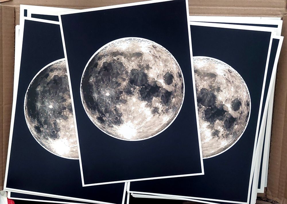 A print of my rendering of the moon against a dark blue background.
