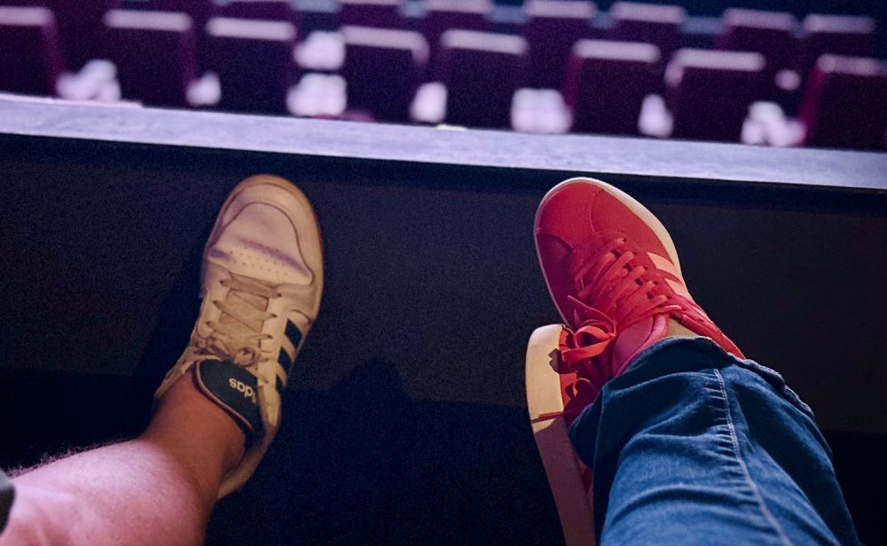 Our legs kicked up in the movie theater 
