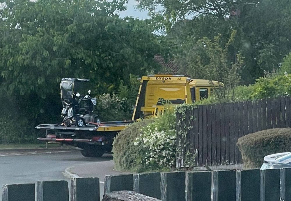 A mobility scooter strapped to the back of a rescue truck