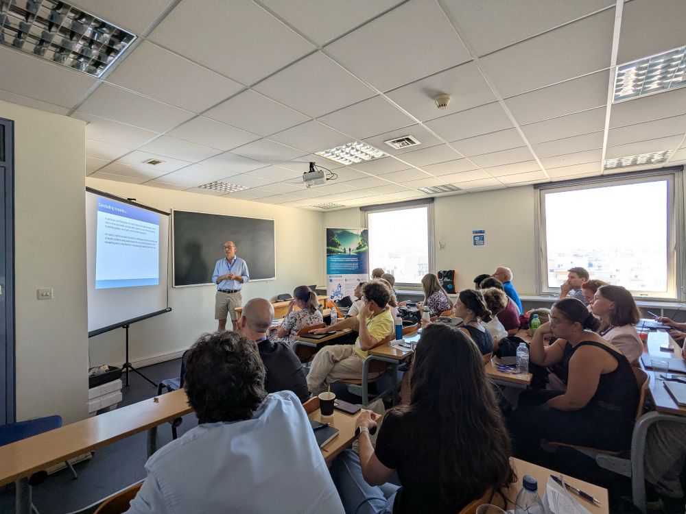 Manos presenting his work in a conference room at ERSA conference.