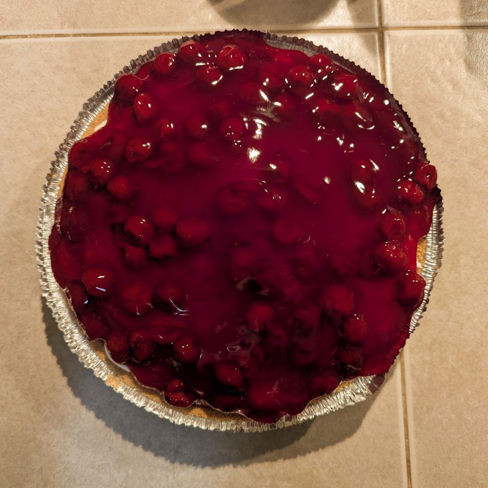 An image of cherry cheese pie, viewed from above