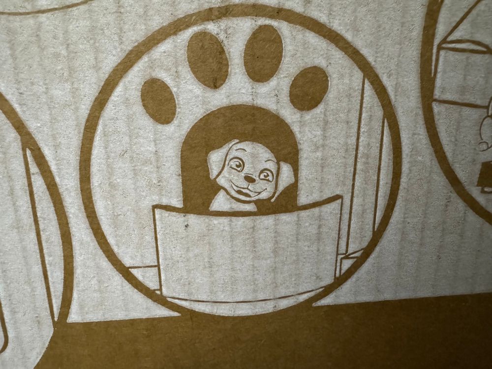 The same puppy sits before some paw-shaped portal, the same expression fixed on its face.