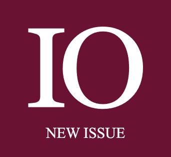 Logo of International Organization - IO and New Issue on a maroon background.