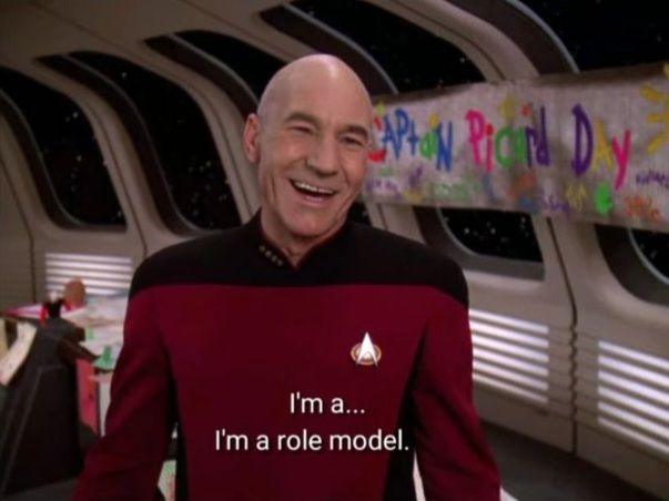 Jean-Luc Picard saying "I'm a... I'm a role model." A colorful banner behind him says "Captain Picard Day" in children's hand writing. 