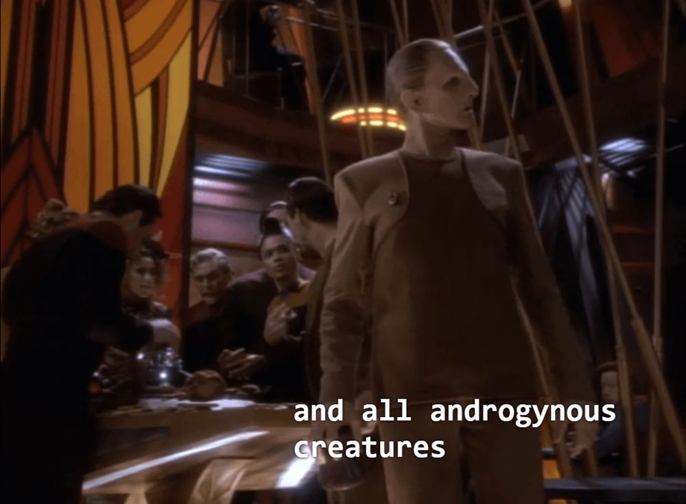 Odo in Quark's Bar addressing "all androgynous creatures"