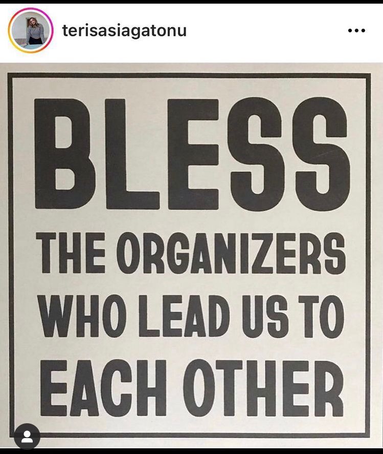 White sign with bold black type reading: “Bless the organizers who lead us to each other” (credit to original IG poster terisasiagatonu) 