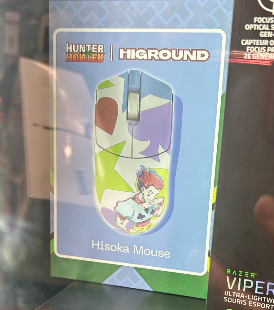A photo of a Highground Hisoka computer mouse, in the case at Microcenter
