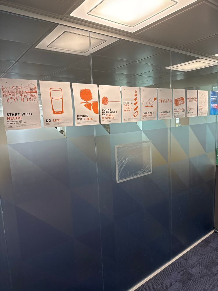Posters on a glass wall showing the 10 government design principles.