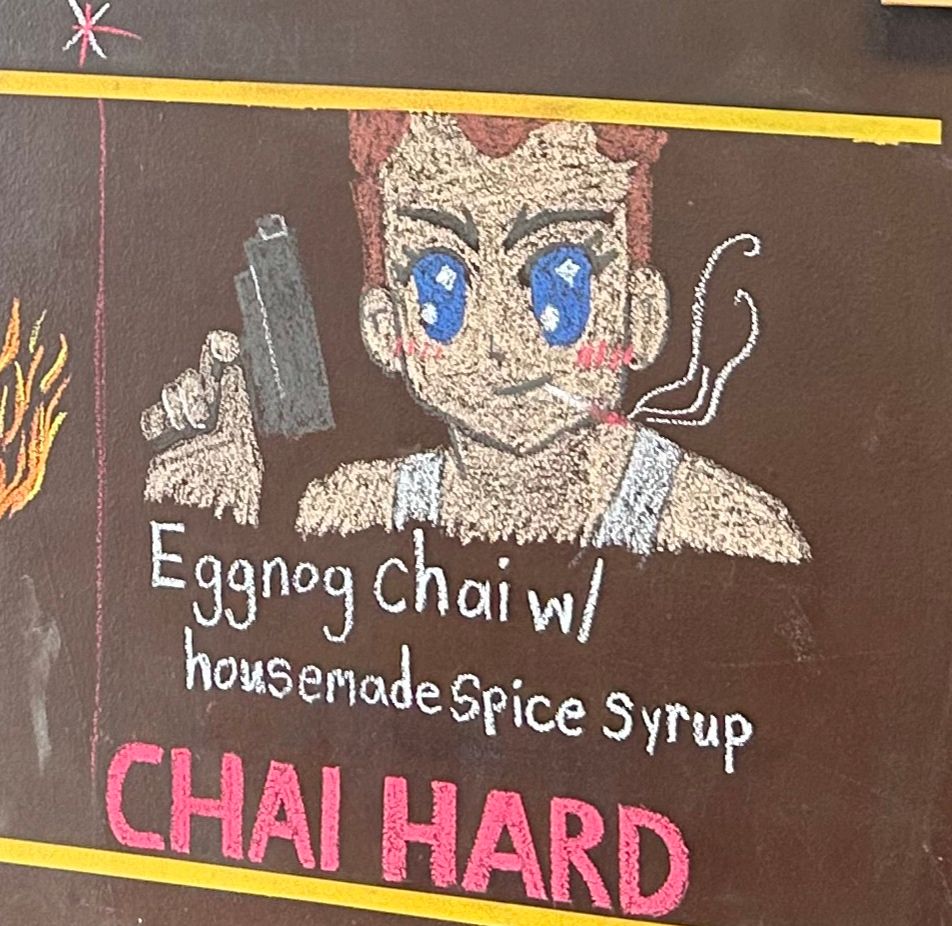 die hard guy drawn w anime eyes and blush on chalk board 