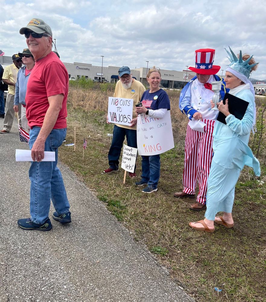 A group of people attending the rally. One is dressed as Lady Liberty and another is dressed as Uncle Sam. 
