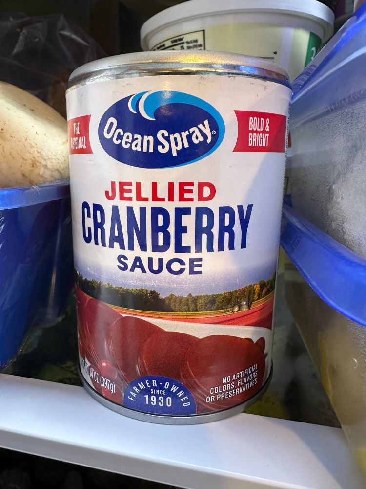 A can of ocean spray jellied cranberry sauce in a fridge. This is the original kind that is best served cold, sliced into discs, and eaten the way the Lord intended for us to eat cranberries.
