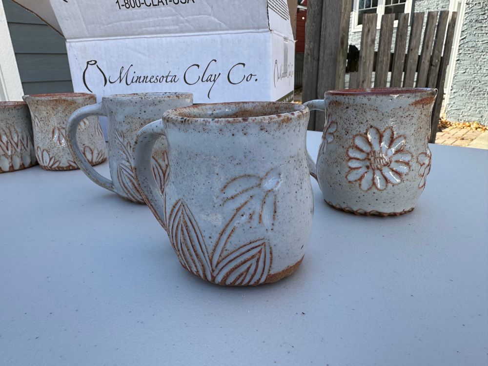 3 carved mugs