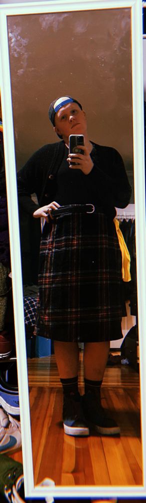 Girl in a plaid skirt and black top i mirror selfie 