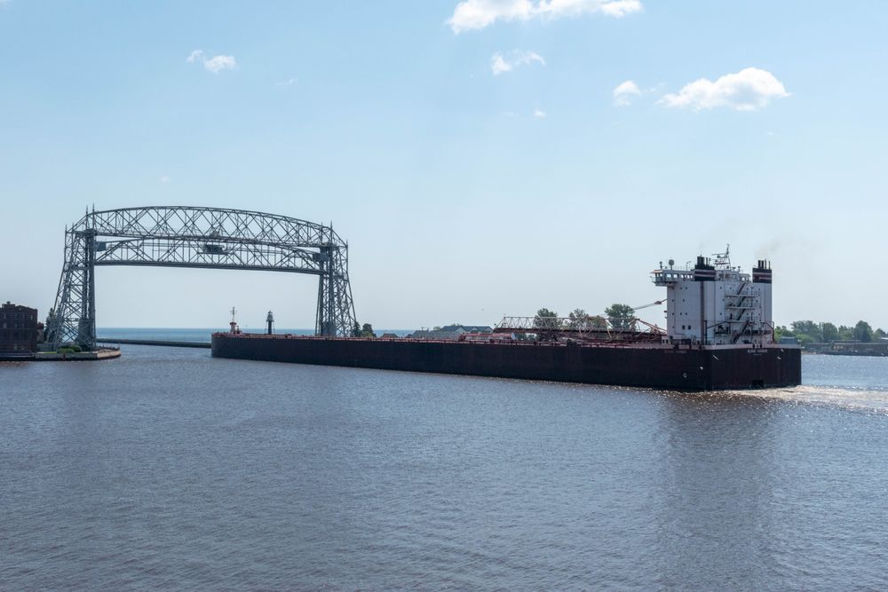 A freighter departing the Port of Duluth-Superior going under the Duluth Aerial Lift Bridge. Credit: MNSG/A. Shie.