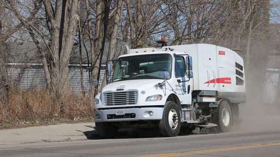 A street sweeper driving down a street.  Image credit: Mississippi Watershed Management/Flickr.