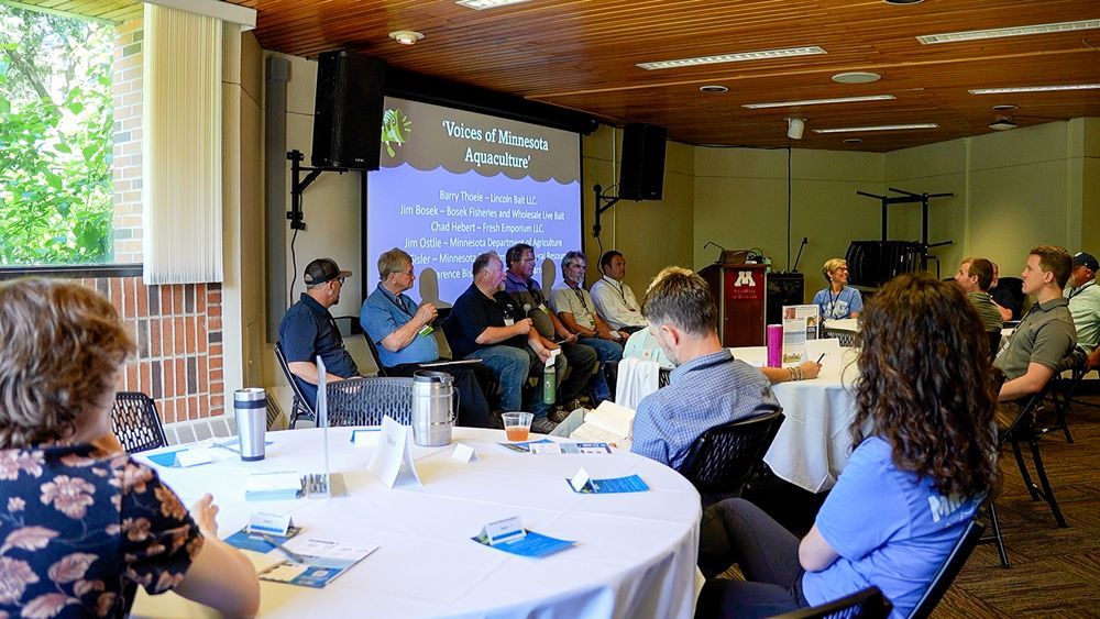 "Voices of Minnesota Aquaculture" panel presentation in front of a room of attendees. Credit: C. Dettmann/MNSG.