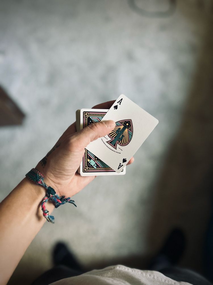 Another picture of me holding the Fulton Playing Cards but instead of being in a box, I have the cards open with the ace of spades on top. 
