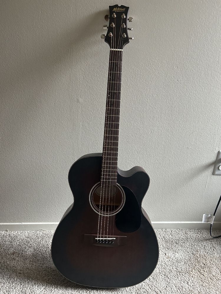 A picture of my new Mitchell guitar, with a solid mahogany top (solid top is a great thing) mahogany back and sides plus a fishman pickup! All for less than 200 hundred bucks. 🤘🏼