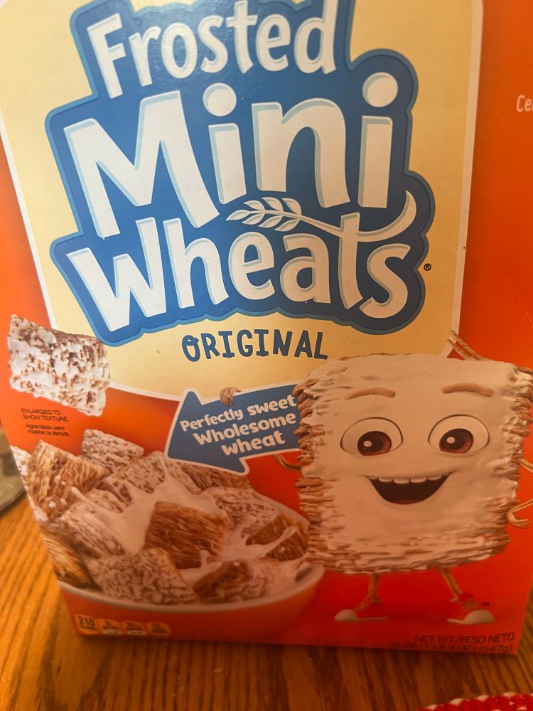 Photo of a box of Frosted Mini Wheats with the mascot character