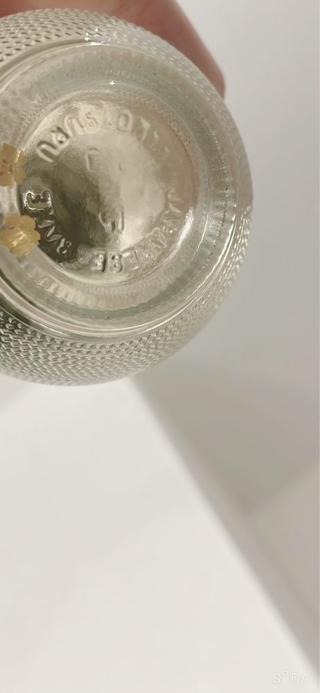 日本酒のボトルの底 桜の花の形の金箔が二枚見える